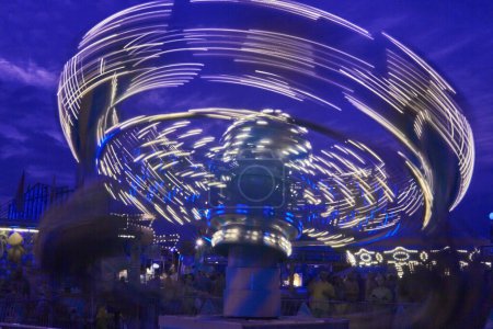 Vibrant long exposure image of a carousel in full swing at the 2017 Allen County Fair in Fort Wayne, Indiana, conveying the thrill and excitement of a night at the amusement park.