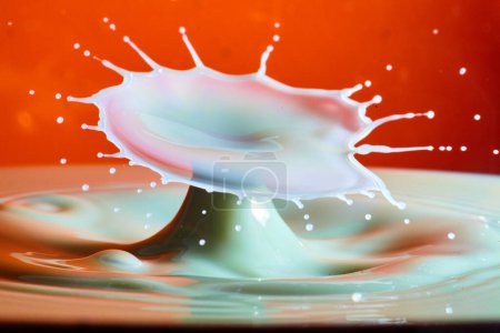 High-Speed Capture of White Liquid Splash Against Orange Backdrop in Studio, 2017, Fort Wayne, Indiana