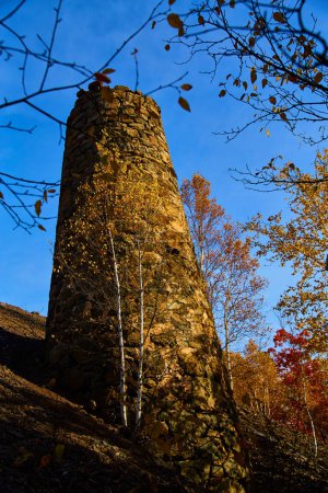 Autumn at Mohawk, Michigan, showcasing a historic stone chimney amidst vibrant fall foliage