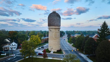 Photo for Serene evening view of historic Ypsilanti Water Tower, Michigan, captured by a drone, featuring tranquil suburban surroundings with minimal traffic - Royalty Free Image