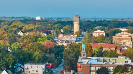 Early morning aerial view of Ypsilanti, Michigan, showcasing the historic water tower, vibrant autumn colors, and a blend of residential and urban architecture.