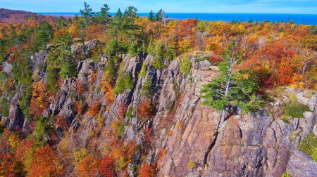 Breathtaking aerial view of a rugged cliff line, adorned with vibrant fall foliage, in Cliff Mine, Michigan, captured with a DJI Phantom 4 drone in 2017