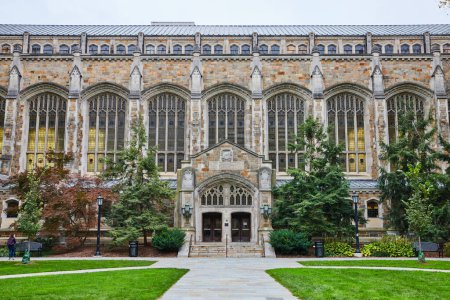 Photo for Gothic architecture of University of Michigan Law Quadrangle, featuring intricate stone carvings and stained glass windows, with a manicured lawn in Ann Arbor, Michigan. - Royalty Free Image