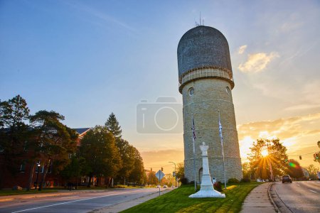 Historic Ypsilanti Water Tower bathed in golden sunrise light, epitomizing quaint small-town America