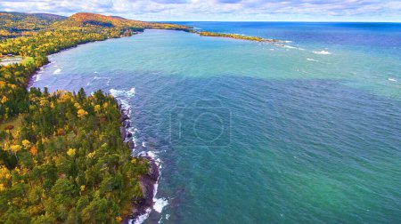 Aerial view of autumn forest hugging rugged coastline of Lake Superior, Michigan, captured by DJI Phantom 4 drone in 2017