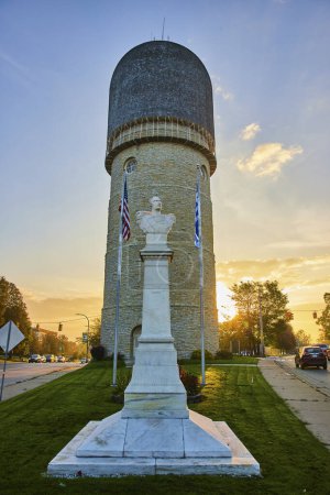 Sunset bathes the historic Ypsilanti Water Tower and nearby monument in golden light, capturing the essence of small-town Americana in Michigan.