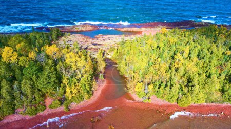 Aerial View of Autumn Transition in Copper Harbor, Michigan, Where Forested River Meets Lake Superior