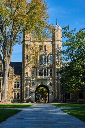 Imposing University of Michigan Law Quadrangle, a historic stone building under vibrant autumn foliage, symbolizing academic excellence and tradition