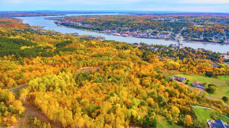 Aerial Autumn View of Houghton, Michigan: Vibrant Fall Foliage Meets Riverside Urban Environment