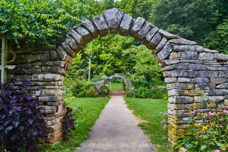 Photo for Stone Arches and Vibrant Garden Pathway in Spring Mills State Park, Indiana - Royalty Free Image