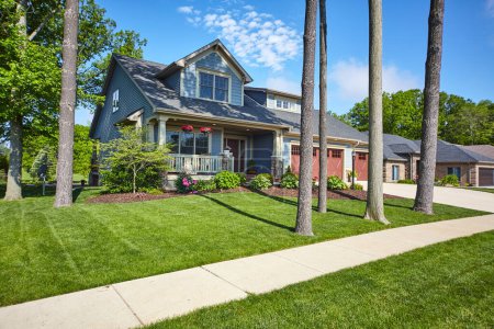 Serene suburban home in Fort Wayne, Indiana, showcasing classic American architecture and meticulous landscape, ideal for realty and residential communities