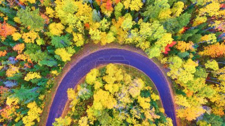 Aerial view of winding road amid autumn splendor in Michigans Copper Harbor, captured by drone in 2017