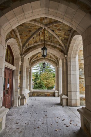 Gothic archway at University of Michigan Law Quadrangle, showcasing architectural elegance and natural tranquility
