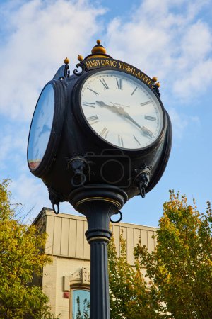 Photo for Elegant Historic Ypsilanti street clock against a clear sky, embodying small-town charm in autumn, Michigan - Royalty Free Image
