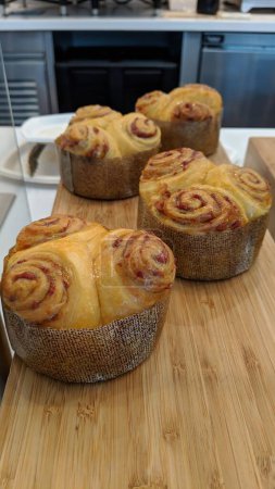 Photo for Freshly baked cinnamon rolls in rustic molds, evoking a warm, gourmet bakery environment - Royalty Free Image