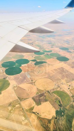 Aerial View of Colorado Farmland from Airplane Wing, Capturing the Patchwork of Irrigated Fields in Summer 2021