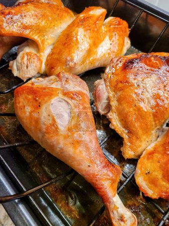 Photo for Golden roasted chicken pieces on wire rack, showcasing home cooking skills for Christmas meal, Fort Wayne, Indiana, 2021 - Royalty Free Image