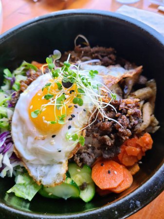 Vibrant 2023 Korean bibimbap dish with fresh ingredients in Fort Wayne, Indiana, highlighting healthy and colorful Asian cuisine.