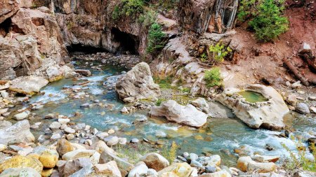 Serene river flowing through rugged canyon with vibrant vegetation, captured in the untouched beauty of Hippie Hot Spring, Ouray, Colorado, 2021