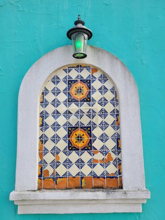 Vibrant Tiled Niche and Classic Lantern on a Colorful Wall in Mount Vernon, Ohio - Cultural Heritage and Architectural Beauty