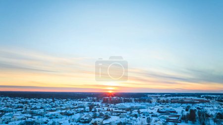 Winter Sunrise Over Snow-Covered Suburban Landscape in Fort Wayne, Indiana, Displaying Tranquil Beauty and Seasonal Change.