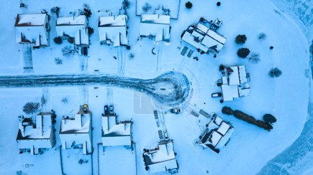 Aerial view of tranquil snow-clad neighborhood in Fort Wayne, Indiana, capturing the serene beauty of winter.