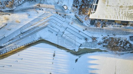Photo for Aerial Golden Hour View of Snow-Covered Staircases and Modern Architecture in Downtown Fort Waynes Promenade Park, Winter - Royalty Free Image