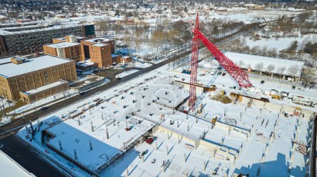 Aerial Winter View of Active Construction Site with Red Crane in Downtown Fort Wayne, Indiana