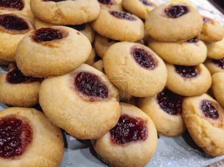 Freshly baked thumbprint cookies with vibrant jam center, perfect for culinary arts and home baking themes, straight from Fort Wayne, Indiana.