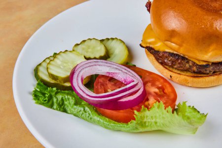 Classic American cheeseburger with fresh vegetable garnishes, a comforting meal from Indianas heartland.