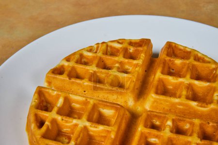 Inviting close-up of a golden-brown waffle on a white plate, perfect for breakfast or brunch in Fort Wayne, Indiana