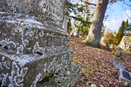 Autumn Afternoon at Indianas Lindenwood Cemetery: Weathered Stone Texture with Lichen, Serene Graveyard Scene