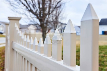 Photo for Peaceful Suburban Scene in Fort Wayne, Indiana, with Prominent White Picket Fence Embodying the American Dream - Royalty Free Image