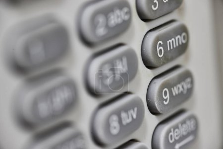 Macro view of a modern office telephone keypad in Fort Wayne, Indiana, focusing on the number 6, symbolizing precision and connectivity.