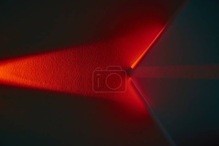 Vibrant Red Beam Illuminating Textured Surface in Abstract Display, Symbolizing Direction and Duality in Fort Wayne Studio