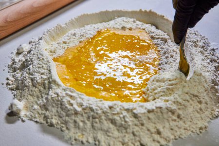 Culinary Artistry in Fort Wayne, Indiana - Homemade Pasta Preparation with Fresh Eggs and Flour