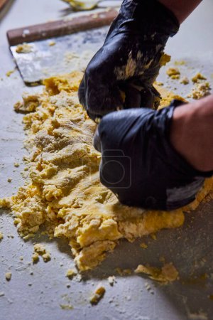 Artisanal Pasta Making in Fort Wayne - Close-Up of Gloved Hands Kneading Fresh Dough