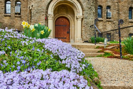 Spring blooms at historic Bishop Simon Brute College in Indianapolis, showcasing natures renewal against timeless stone architecture.