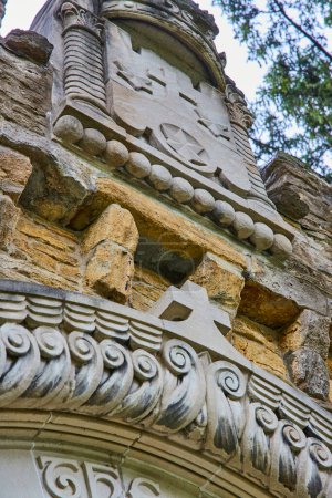Daylight Highlights Craftsmanship on Historic Bishop Simon Brute College Stonework in Spring, a Testament to Indianas Religious Heritage.