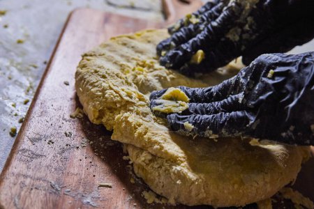 Gloved hands gently break apart a golden homemade rustic bread loaf, Fort Wayne, Indianas bakery scene