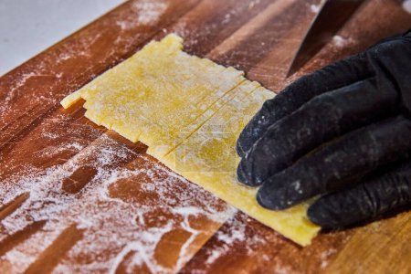 Artisan Chef at Work: Handcrafting Authentic Tagliolini Pasta in a Cozy Fort Wayne Kitchen