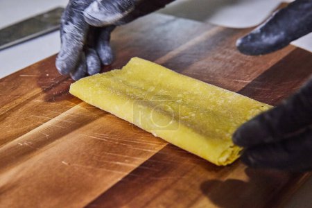Authentic homemade pasta preparation in a rustic kitchen setting, showcasing culinary craftsmanship in Fort Wayne, Indiana.