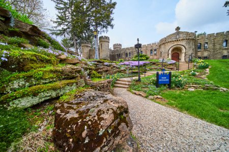 Springtime at the historic Bishop Simon Brute College in Indiana, showcasing medieval architecture and a vibrant garden.
