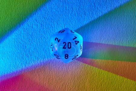 Dazzling rainbow spectrum illuminates a translucent twenty-sided die, symbolizing success and the vibrant world of fantasy gaming.