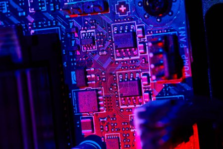 Photo for Macro shot of computer motherboard in striking blue and purple light, highlighting the intricacy of tech design in Fort Wayne, Indiana. - Royalty Free Image