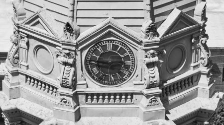 Photo for Timeless elegance in architecture: Black and White Vintage clock with Roman numerals set in an ornate pediment, Warsaw. - Royalty Free Image