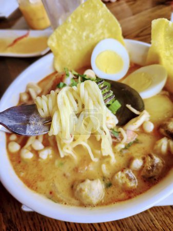 Savor the warmth of Thai laksa: creamy broth, lush noodles, and vibrant herbs, in a casual Fort Wayne eatery.