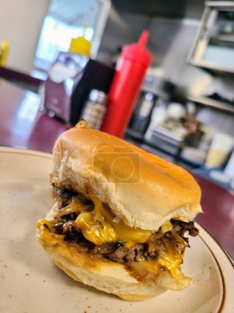 Savor the classic American diner experience with this tempting cheeseburger, fresh off the grill in Fort Wayne.