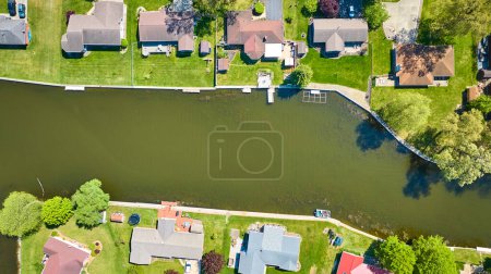 Photo for Aerial view of a peaceful riverfront neighborhood in Warsaw, Indiana, showcasing affluent suburban living. - Royalty Free Image