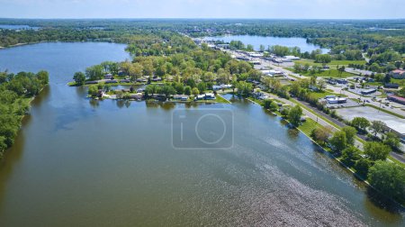 Vista aérea de una vibrante comunidad junto al lago en Varsovia, Indiana, mostrando exuberantes paisajes y vida moderna.